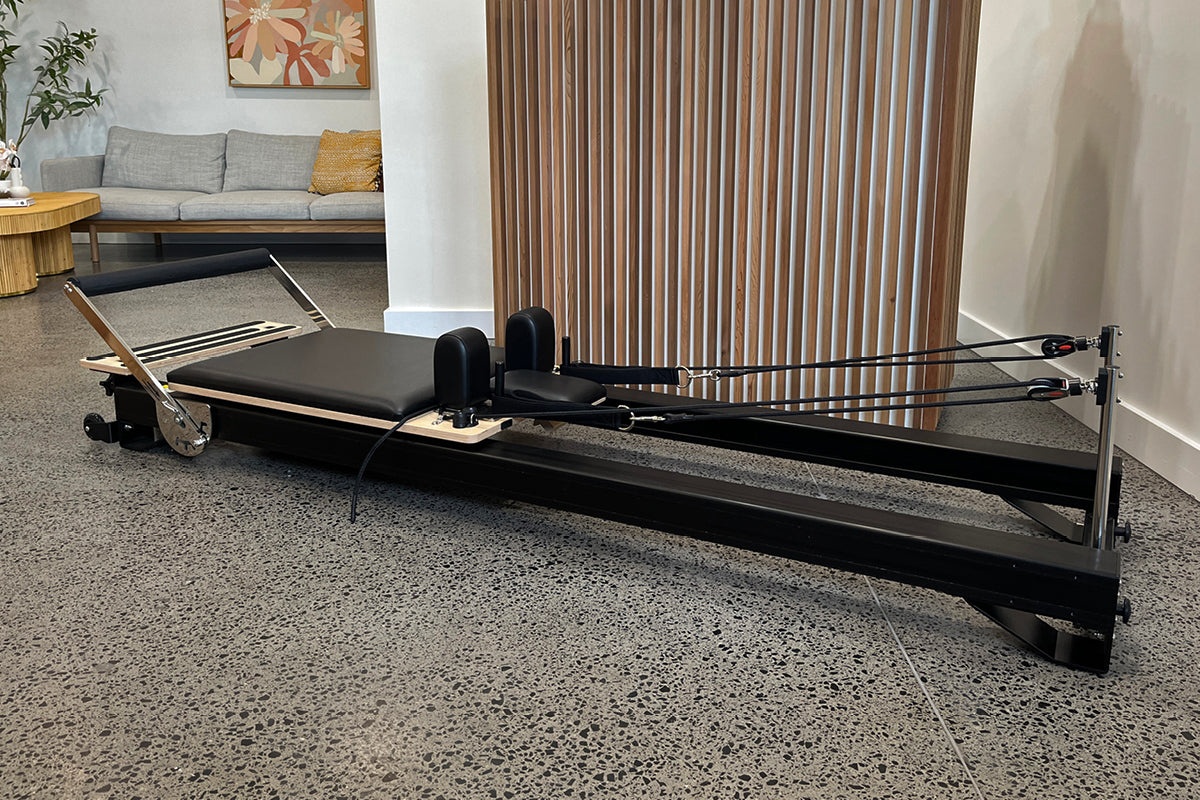 Studio X Black Reformer in Modern Living Room - Side View | Your Reformer
